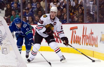 VANCOUVER, CANADA - APRIL 13: Jonathan Toews #19 of the Chicago Blackhawks tries to get to the front of the net while being defended by Ryan Kesler #17 of the Vancouver Canucks during the first period in Game One of the Western Conference Quarterfinals du