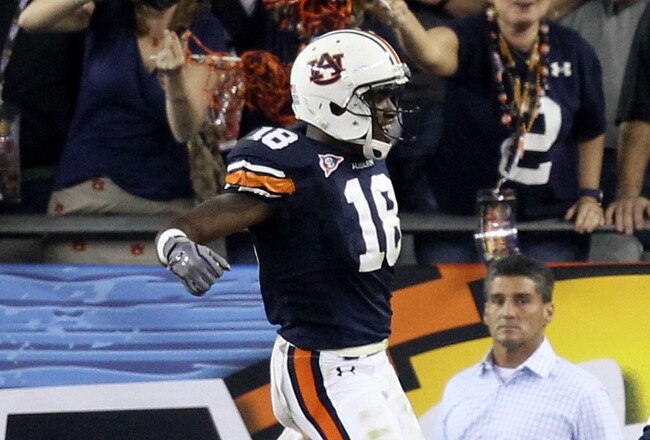 GLENDALE, AZ - JANUARY 10:  Michael Dyer #5 of the Auburn Tigers celebrates with teammates Brandon Mosley #75 and Kodi Burns #18 after he ran the ball for 16-yards and is called down at the one-yardline with 10 seconds remaining in the fourth quarter agai