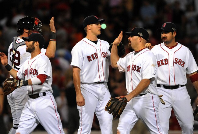 BOSTON, MA - JULY 9: Red Sox players Dustin Pedrioa #15, Jarrod Saltalamacchia #38, Jonathan Papelbon #58, Kevin Youkilis #20 and Adrian Gonzalez #28 congratulate each other after their win against the Baltimore Orioles at Fenway Park on July 9, 2011 in B