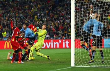 JOHANNESBURG, SOUTH AFRICA - JULY 02:  Luis Suarez of Uruguay handles the ball on the goal line, for which he is sent off, during the 2010 FIFA World Cup South Africa Quarter Final match between Uruguay and Ghana at the Soccer City stadium on July 2, 2010