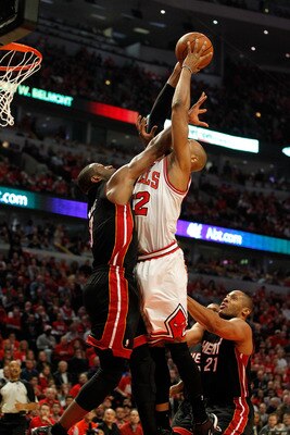 CHICAGO, IL - MAY 15:  Taj Gibson #22 of the Chicago Bulls dunks against Dwyane Wade #3 of the Miami Heat in Game One of the Eastern Conference Finals during the 2011 NBA Playoffs on May 15, 2011 at the United Center in Chicago, Illinois. The Bulls won 10