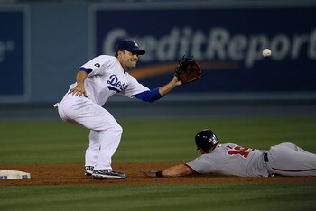 LOS ANGELES, CA - JULY 22:   Second baseman Jamey Carroll #14 of the Los Angeles Dodgers takes the throw before tagging out Lance Nix #19 of the Washington Nationals trying to steal second base on July 22, 2011 at Dodger Stadium in Los Angeles, California