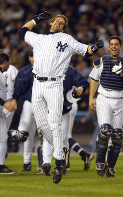 BRONX, NY - OCTOBER 16:  Aaron Boone #19 of the New York Yankees celebrates after hitting the game winning home run in the bottom of the eleventh inning against the Boston Red Sox during game 7 of the American League Championship Series on October 16, 200