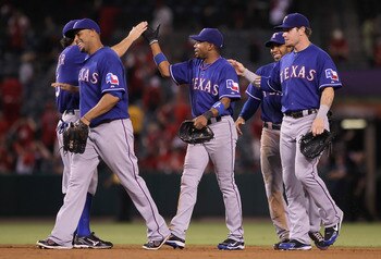 ANAHEIM, CA - JULY 19:  (L-R) Nelson Cruz #17, Endy Chavez #9, Elvis Andrus #1 and Josh Hamilton #32 of the Texas Rangers congratulate each other following their teams victory over the Los Angeles Angels of Anaheim at Angel Stadium of Anaheim on July 19,