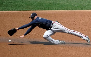 SAN DIEGO, CA - JUNE 26: Freddie Freeman #5 of the Atlanta Braves dives for a single hit by Will Venable #25 of the San Diego Padres during the third inning of a baseball game at Petco Park on June 26, 2011 in San Diego, California. Freeman was unable to