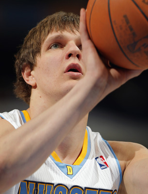 DENVER, CO - MARCH 21:  Timofey Mozgov #25 of the Denver Nuggets takes a free throw against the Toronto Raptors at the Pepsi Center on March 21, 2011 in Denver, Colorado. The Nuggets defeated the Raptors 123-90. NOTE TO USER: User expressly acknowledges a