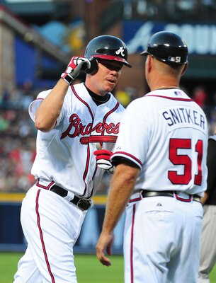 ATLANTA - JULY 6: Chipper Jones #10 of the Atlanta Braves is congratulated by Brian Snitker #51 after hitting a 3rd inning home run against the Colorado Rockies at Turner Field on July 6, 2011 in Atlanta, Georgia. (Photo by Scott Cunningham/Getty Images)