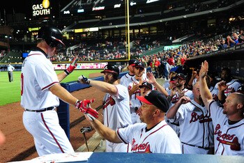 ATLANTA - JULY 25: Chipper Jones #10 of the Atlanta Braves is congratulated by teammates after hitting a home run against the Pittsburgh Pirates at Turner Field on July 25, 2011 in Atlanta, Georgia. (Photo by Scott Cunningham/Getty Images)