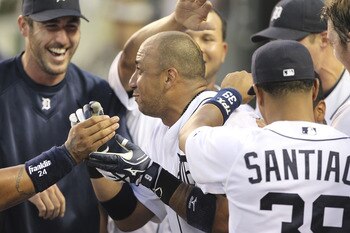 DETROIT - JULY 19:  Carlos Guillen #9 of the Detroit Tigers hits a two run home run in the fifth inning and is congratulated by teammates during the game against the Oakland Athletics at Comerica Park on July 19, 2011 in Detroit, Michigan.  (Photo by Leon