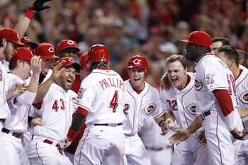 CINCINNATI, OH - JULY 15: Brandon Phillips #4 of the Cincinnati Reds celebrates with teammates after hitting the game-winning home run in the bottom of the ninth inning against the St. Louis Cardinals at Great American Ball Park on July 15, 2011 in Cincin