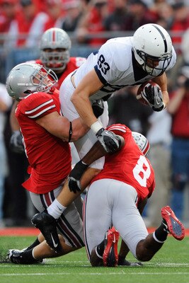 COLUMBUS, OH - NOVEMBER 13:  Brett Brackett #83 of the Penn State Nittany Lions is tackled by Ross Homan #51 of the Ohio State Buckeyes and Aaron Gant #8 of the Ohio State Buckeyes after making a pass reception at Ohio Stadium on November 13, 2010 in Colu