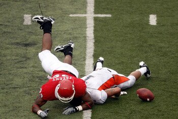 PISCATAWAY, NJ - SEPTEMBER 27: Defensive end Jonathan Freeny #99 of the Rutgers Scarlet Knights forces a fumble by quarterback Carlton Jackson #1 of the Morgan State Bears during the second quarter at Rutgers Stadium on September 27, 2008 in Piscataway, N