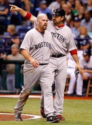 ST. PETERSBURG, FL - JULY 16:  Infielder Adrian Gonzalez #28 of the Boston Red Sox thanks the crowd as Kevin Youkilis #20 looks on against the Tampa Bay Rays during the game at Tropicana Field on July 16, 2011 in St. Petersburg, Florida.  (Photo by J. Mer