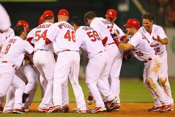 ST. LOUIS, MO - JULY 9: Tony Cruz #48 of the St. Louis Cardinals is mobbed by teammates after hitting a walk-off double against the Arizona Diamondbacks at Busch Stadium on July 9, 2011 in St. Louis, Missouri.  The Cardinals beat the Diamondbacks 7-6.  (P