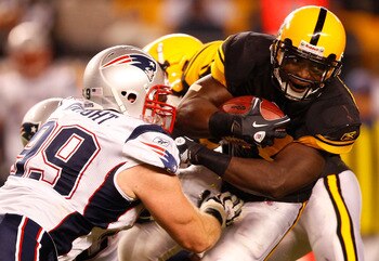 PITTSBURGH, PA - NOVEMBER 14:  Rashard Mendenhall #34 of the Pittsburgh Steelers attempts to run through Mike Wright #99 of the New England Patriots during the game on November 14, 2010 at Heinz Field in Pittsburgh, Pennsylvania.  (Photo by Jared Wickerha