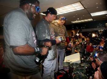 DENVER - OCTOBER 28:  (L-R) David Ortiz, Josh Beckett and Jonathan Papelbon of the Boston Red Sox celebrate with the trophy in the locker room after winning Game Four by a score of 4-3 to win the 2007 Major League Baseball World Series in a four game swee