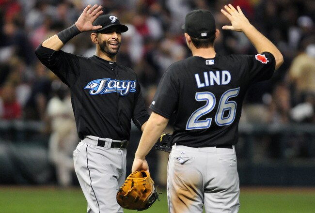 CLEVELAND, OH - JULY 9:  Jose Bautista #19 and Adam Lind #26 of the Toronto Blue Jays celebrate after defeating the Indians 5-4 in 10 innings at Progressive Field on July 9, 2011 in Cleveland, Ohio. (Photo by Jason Miller/Getty Images)
