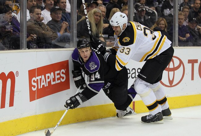 LOS ANGELES, CA - JANUARY 24:  Zdeno Chara #33 of the Boston Bruins checks Ryan Smyth #94 of the Los Angeles Kings into the boards at Staples Center on January 24, 2011 in Los Angeles, California.  (Photo by Jeff Gross/Getty Images)