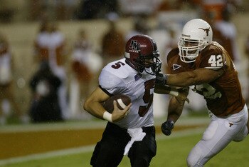 AUSTIN, TX - AUGUST 31:  Quarterback Joey Vincent #5 of the New Mexico State University Aggies is tackled for a loss by defensive end Chase Pittman #42 of the University of Texas at Austin Longhorns at Texas Memorial Stadium on August 31, 2003 in Austin, 