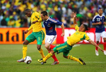 BLOEMFONTEIN, SOUTH AFRICA - JUNE 22: Anele Ngcongca and Steven Pienaar of South Africa tackle Franck Ribery of France during the 2010 FIFA World Cup South Africa Group A match between France and South Africa at the Free State Stadium on June 22, 2010 in