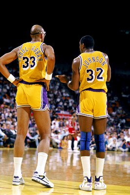 LOS ANGELES - 1988:  Kareem Abdul-Jabbar #33 of the Los Angeles Lakers listens to Magic Johnson #32 during an NBA game at the Great Western Forum in Los Angeles, California in 1988. (Photo by Mike Powell/Getty Images)