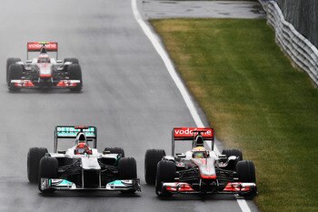MONTREAL, CANADA - JUNE 12:  Michael Schumacher (L) of Germany and Mercedes GP and Lewis Hamilton of Great Britain and McLaren drive side by side during the Canadian Formula One Grand Prix at the Circuit Gilles Villeneuve on June 12, 2011 in Montreal, Can