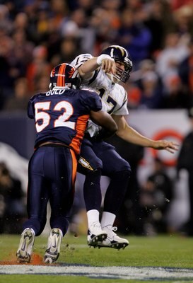 DENVER - NOVEMBER 19:  Quarterback Philip Rivers #17 of the San Diego Chargers releases the ball as he is hit by Ian Gold #52 of the Denver Broncos during NFL action on November 19, 2006 at Invesco Field at Mile High in Denver, Colorado.  (Photo by Doug P