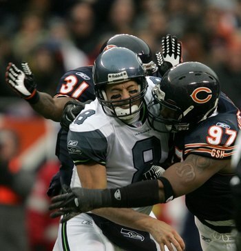 CHICAGO - JANUARY 14: Matt Hasselbeck #8 of the Seattle Seahawks takes a hit from Mark Anderson #97 and Nathan Vasher #31 of the Chicago Bears after throwing a pass during their NFC Divisional Playoff game on January 14, 2007 at Soldier Field in Chicago,