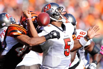 CINCINNATI, OH - OCTOBER 10:  Quarterback Josh Freeman #5 of the Tampa Bay Buccaneers is hit just as he is about to throw by Chris Crocker #42 of the Cincinnati Bengals causing him to fumble at Paul Brown Stadium on October 10, 2010 in Cincinnati, Ohio. T
