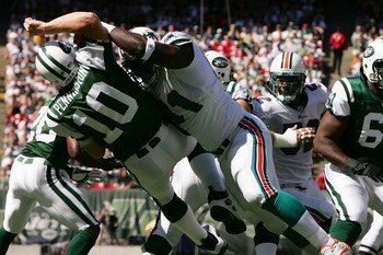 EAST RUTHERFORD, NJ - SEPTEMBER 23:  Chad Pennington #10 of the New York Jets is hit by Vonnie Holiday #91 of the Miami Dolphins in the first quarter during their game on September 23, 2007 at Giants Stadium in East Rutherford, New Jersey.  (Photo by Al B