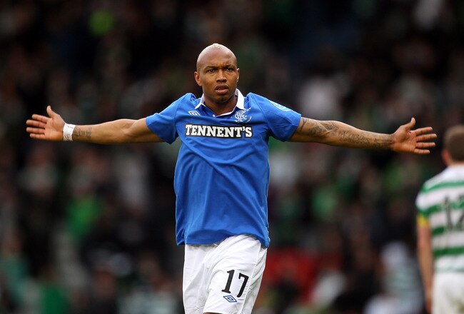 GLASGOW, SCOTLAND - MARCH 20:  El Hadji Diouf of Rangers celebrates in front of the Rangers fans during the Co-operative Insurance Cup final between Celtic and Rangers at Hampden Park on March 20, 2011 in Glasgow, Scotland.  (Photo by Julian Finney/Getty 