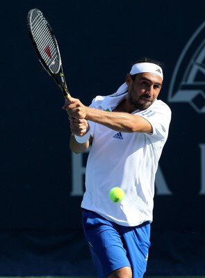 LOS ANGELES, CA - JULY 27:  Marcos Baghdatis of Cyprus hits a return to Yen-Hsun Lu of Chinese Taipei during Day 3 of the Farmers Classic presented by Mercedes-Benz at the LA Tennis Center on July 27, 2011 in Los Angeles, California.  Lu won 6-3, 6-4.  (P