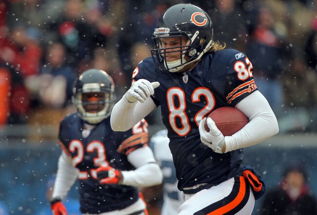 CHICAGO, IL - JANUARY 16:  Tight end Greg Olsen #82 of the Chicago Bears runs after he catches a 58-yard touchdown in the first quarter in front of Lawyer Milloy #36 of the Seattle Seahawks in the 2011 NFC divisional playoff game at Soldier Field on Janua