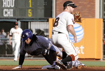 SAN FRANCISCO, CA - JULY 23: Rickie Weeks #23 of the Milwaukee Brewers steals second base beating the tag of Jeff Keppinger #8 of the San Francisco Giants in the first inning during an MLB baseball game at AT&T Park July 23, 2011 in San Francisco, Califor