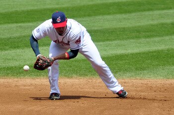 CLEVELAND, OH - JULY 27: Shortstop Asdrubal Cabrera #13 of the Cleveland Indians bobbles a ground ball during the third inning against the Los Angeles Angels of Anaheim at Progressive Field on July 27, 2011 in Cleveland, Ohio. (Photo by Jason Miller/Getty