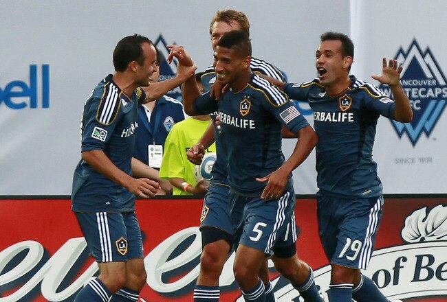 VANCOUVER, CANADA - JULY 30:  Goal-scorer Sean Franklin #5 of the Los Angeles Galaxy is congratulated by teammates Landon Donovan #10, Juninho #19 and Adam Cristman #17 during their MLS game against the Vancouver Whitecaps FC July 30, 2011 at Empire Field