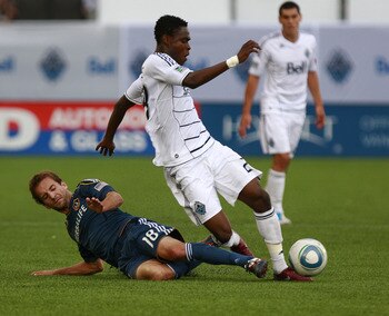 VANCOUVER, CANADA - JULY 30:  Mike Magee #18 of the Los Angeles Galaxy tackles Gershon Koffie #28 of the Vancouver Whitecaps FC during their MLS game July 30, 2011 at Empire Field in Vancouver, British Columbia, Canada. L.A. won 4-0. (Photo by Jeff Vinnic