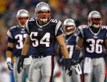 FOXBOROUGH, MA - DECEMBER 23: Tedy Bruschi #54 of the New England Patriots leads the defense of Rodney Harrison #37, Ellis Hobbs #27 and James Sanders #36 against the Miami Dolphins at Gillette Stadium on December 23, 2007 in Foxborough, Massachusetts. Pa