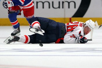 NEW YORK, NY - APRIL 20:  Alexander Semin #28 of the Washington Capitals looks back for the puck as he falls to the ice against the New York Rangers in Game Four of the Eastern Conference Quarterfinals during the 2011 NHL Stanley Cup Playoffs at Madison S