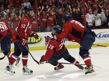 WASHINGTON, DC - APRIL 13:  Alex Ovechkin #8 and Alexander Semin #28 of the Washington Capitals celebrtae Semin's game winning goal at 18:24 of overtime against the New York Rangers in Game One of the Eastern Conference Quarterfinals during the 2011 NHL S
