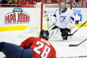WASHINGTON, DC - APRIL 29:  Dwayne Roloson #35 of the Tampa Bay Lightning make a save after Alexander Semin #28  of the Washington Capitals hits the post during Game One of the Eastern Conference Semifinal during the 2011 NHL Stanley Cup Finals at the Ver