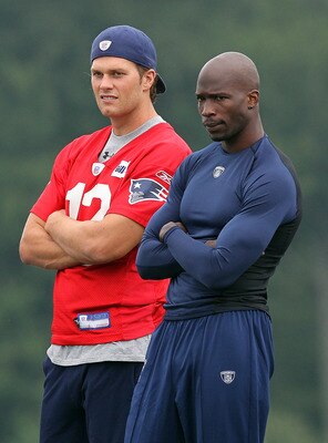 FOXBOROUGH, MA  - JULY 29:  Tom Brady #12 and Chad Ochocinco of the New England Patriots chat during training camp at Gillette Stadium on July 29, 2011 in Foxborough, Massachusetts.  (Photo by Jim Rogash/Getty Images)