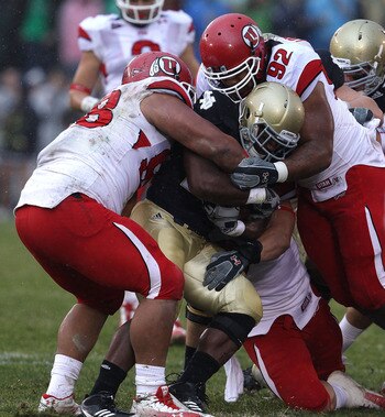 SOUTH BEND, IN - NOVEMBER 13: Sealver Siliga #98 and Star Lotulelei #92 of the Utah Utes stop Jonas Gray #25 of the Notre Dame Fighting Irish at Notre Dame Stadium on November 13, 2010 in South Bend, Indiana. Notre Dame defeated Utah 28-3. (Photo by Jonat