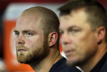 PHOENIX, AZ - MAY 18:  Brian McCann #16 and 	Chipper Jones #10 of the Atlanta Braves watch from the dugout during the Major League Baseball game against the Arizona Diamondbacks at Chase Field on May 18, 2011 in Phoenix, Arizona.  The Diamondbacks defeate