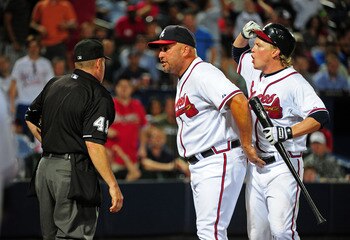 ATLANTA - JULY 26: Manager Fredi Gonzalez #33 and Nate McLouth #13 of the Atlanta Braves discusses a call with Umpire Jerry Meals during the game against the Pittsburgh Pirates at Turner Field on July 26, 2011 in Atlanta, Georgia. Gonzalez and McLouth wou
