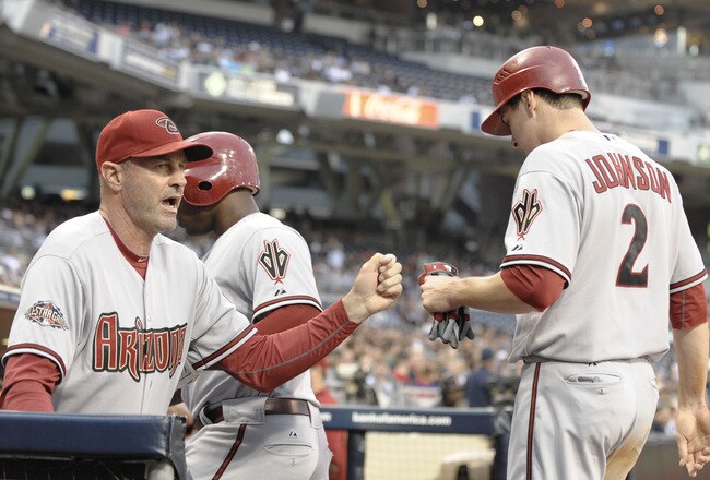 SAN DIEGO, CA - JULY 26:  Kelly Johnson #2 of the Arizona Diamondbacks is congratulated by manager Kirk Gibson after Johnson hit an RBI triple during the third inning of a baseball game against the San Diego Padres at Petco Park on July 26, 2011 in San Di