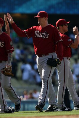 LOS ANGELES, CA - JULY 31:  J.J. Putz #40 of the Arizona Diamondbacks high-fives teammates after the victory against the Los Angeles Dodgers at Dodger Stadium on July 31, 2011 in Los Angeles, California.  Putz recorded two outs in the ninth inning to earn