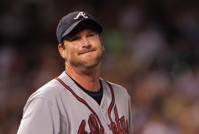 DENVER, CO - JULY 18:  Starting pitcher Derek Lowe #32 of the Atlanta Braves reacts as he works against the Colorado Rockies at Coors Field on July 18, 2011 in Denver, Colorado. Lowe earned the win as the Braves defeated the Rockies 7-4.  (Photo by Doug P