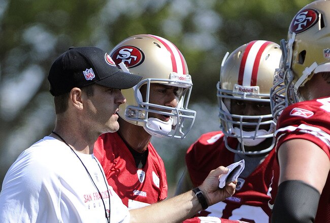 SANTA CLARA, CA - JULY 30: Head coach Jim Harbaugh of the San Francisco 49ers gives a play to his offense during practice at the San Francisco 49ers training facility on July 30, 2011 in Santa Clara, California. (Photo by Thearon W. Henderson/Getty Images