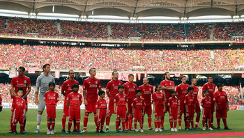 KUALA LUMPUR, MALAYSIA - JULY 16: Liverpool lines up during the pre-match ceremony during the pre-season friendly match between Malaysia and Liverpool at the Bukit Jalil National Stadium on July 16, 2011 in Kuala Lumpur, Malaysia. (Photo by Stanley Chou/G